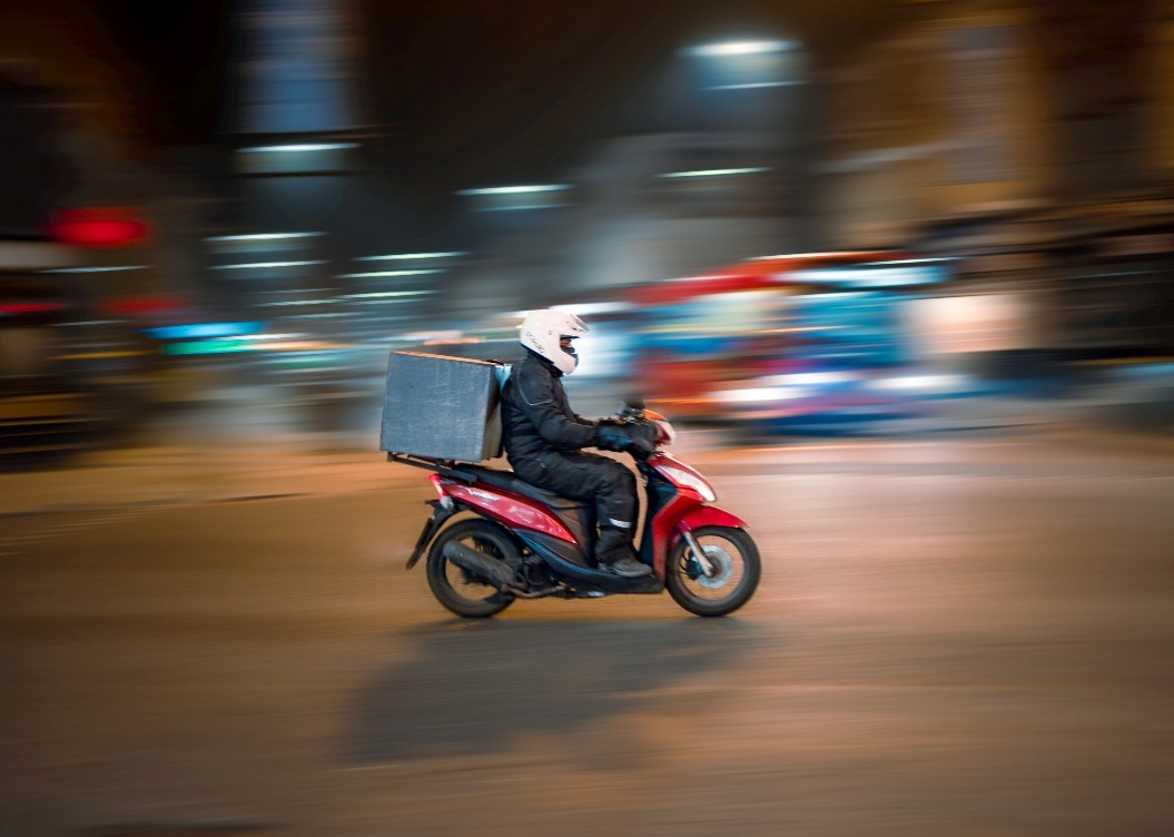 Delivery person on a bike.