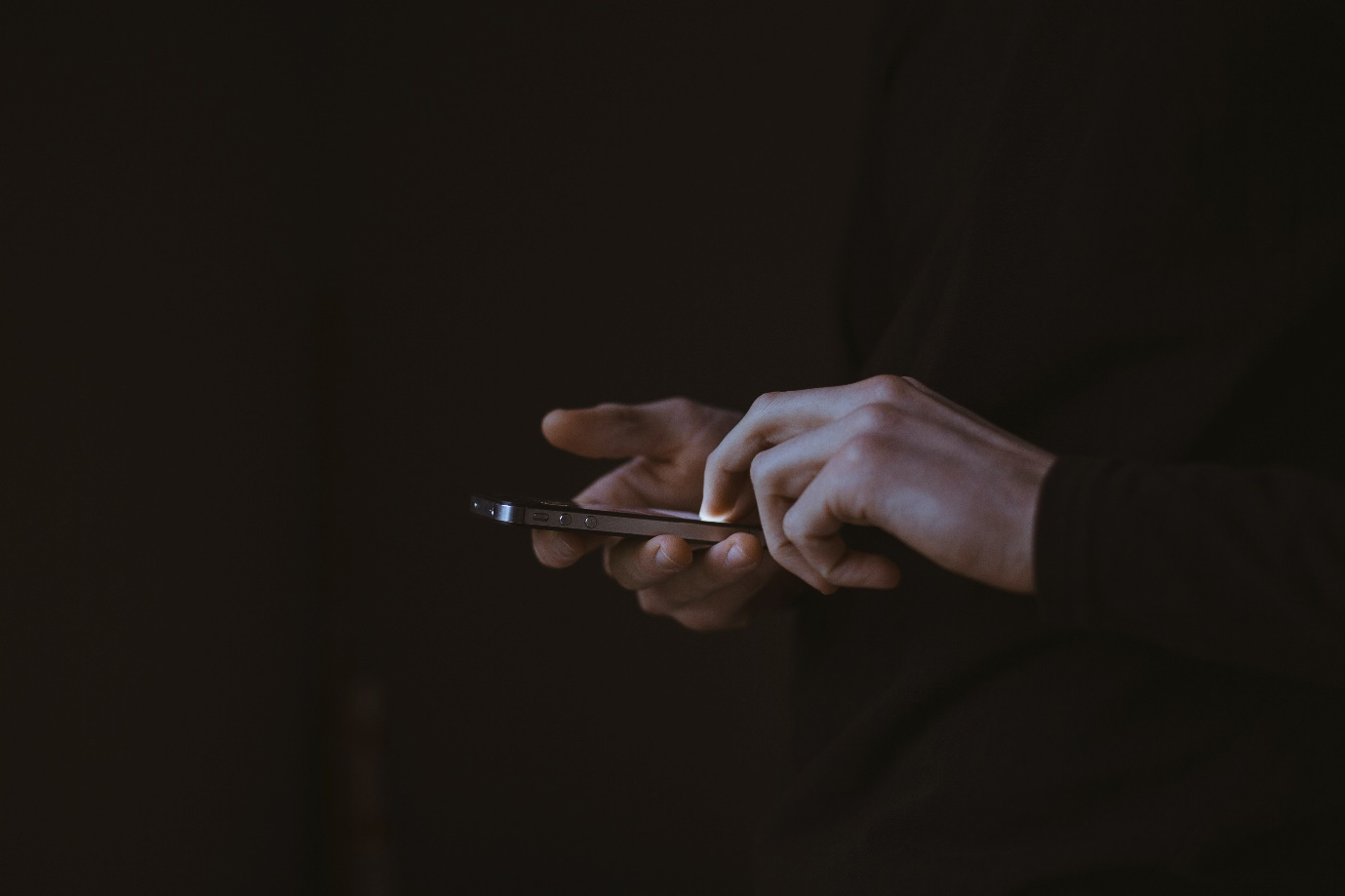 Person holding smartphone in their hand.